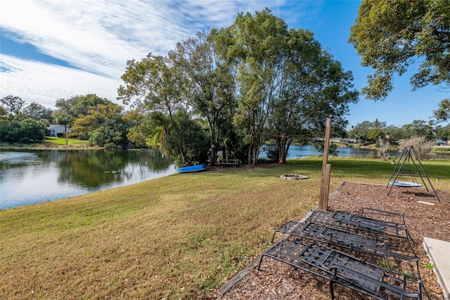 view of yard featuring a fire pit and a water view