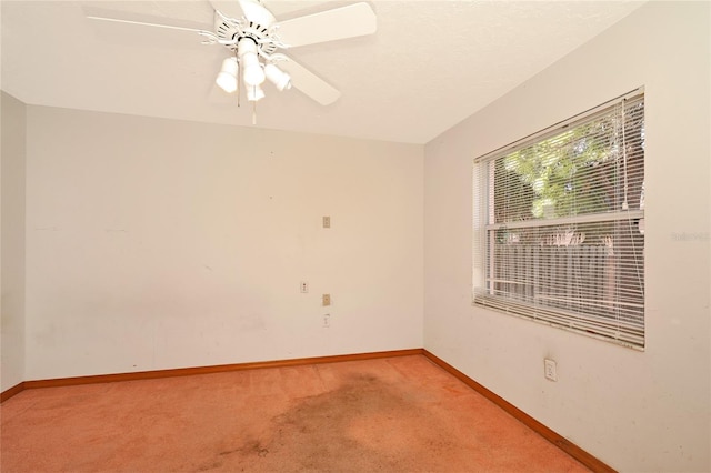 empty room featuring light colored carpet and ceiling fan