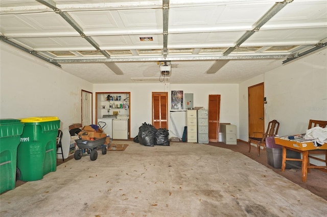 garage with electric panel, a garage door opener, and washing machine and clothes dryer