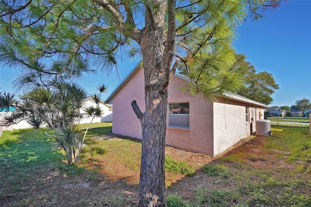 view of home's exterior with a yard and cooling unit