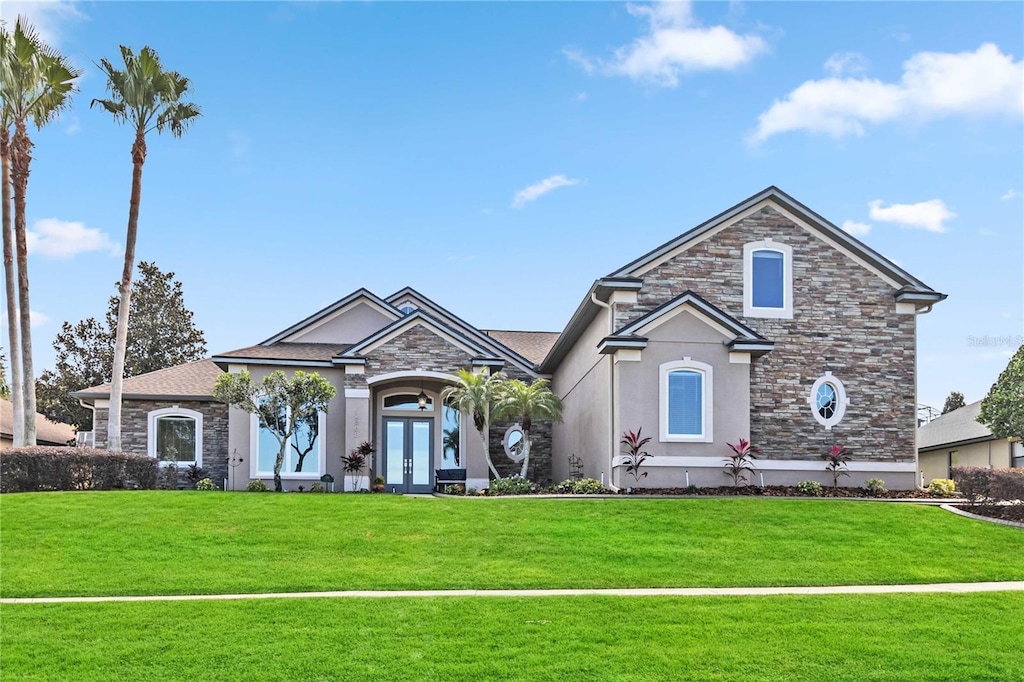 view of front facade with a front lawn and french doors