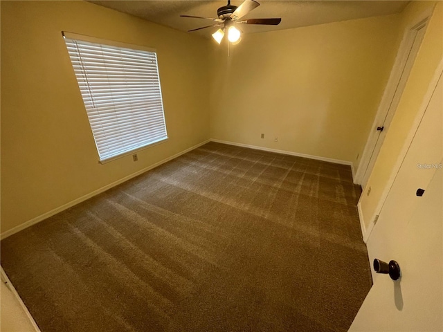 carpeted spare room with ceiling fan