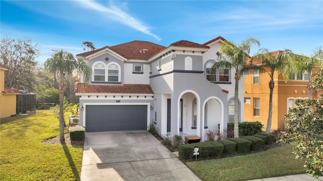 mediterranean / spanish home with a garage and a front yard