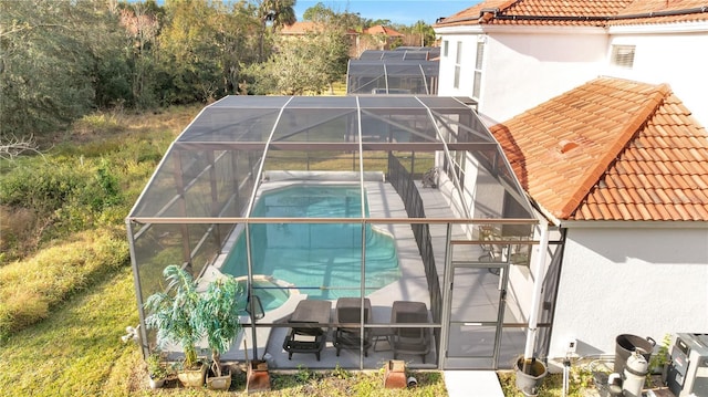 exterior space featuring a patio and glass enclosure