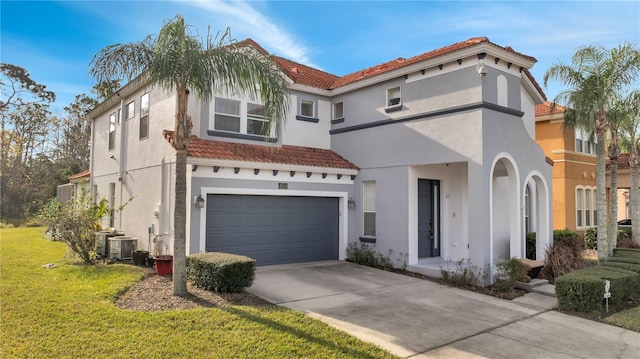 mediterranean / spanish-style house with cooling unit, a garage, and a front yard