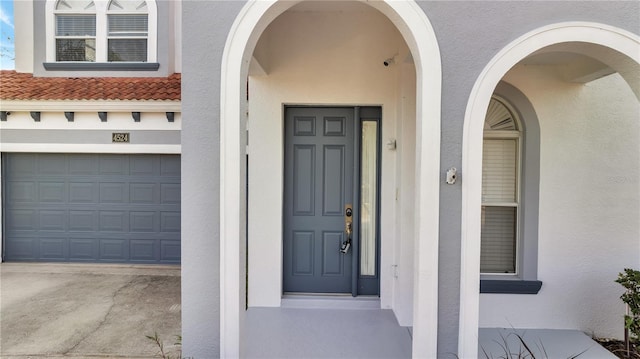 doorway to property with a garage