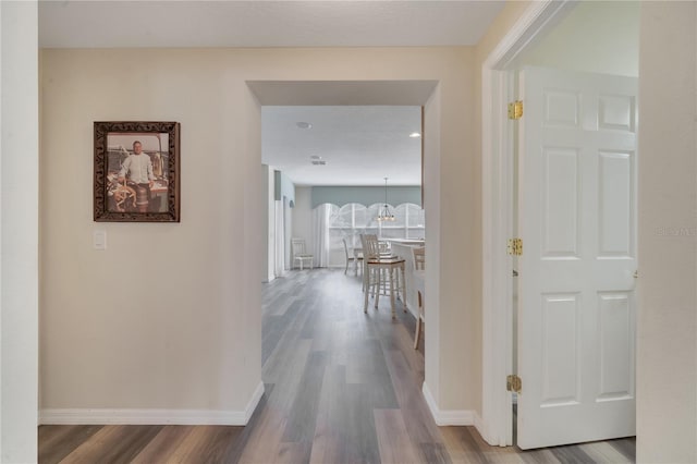 corridor with hardwood / wood-style floors