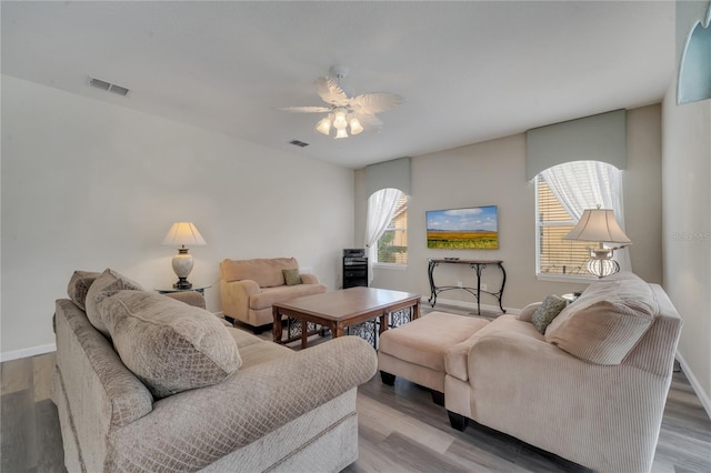 living room with a wealth of natural light, hardwood / wood-style floors, and ceiling fan