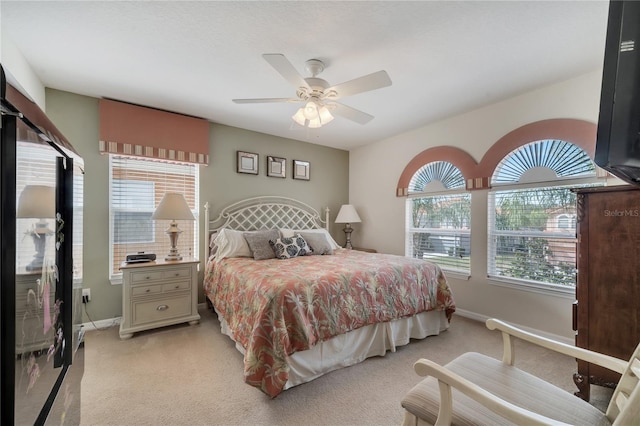 bedroom featuring ceiling fan and light colored carpet