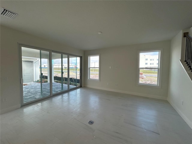 unfurnished room featuring a wealth of natural light