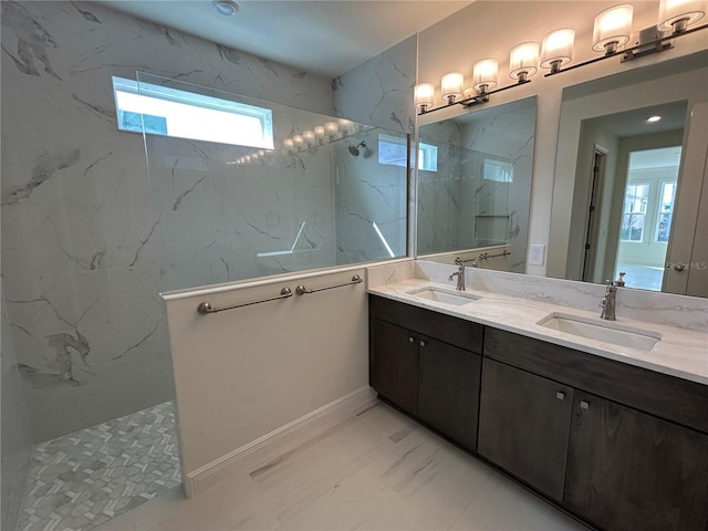 bathroom with vanity and a tile shower