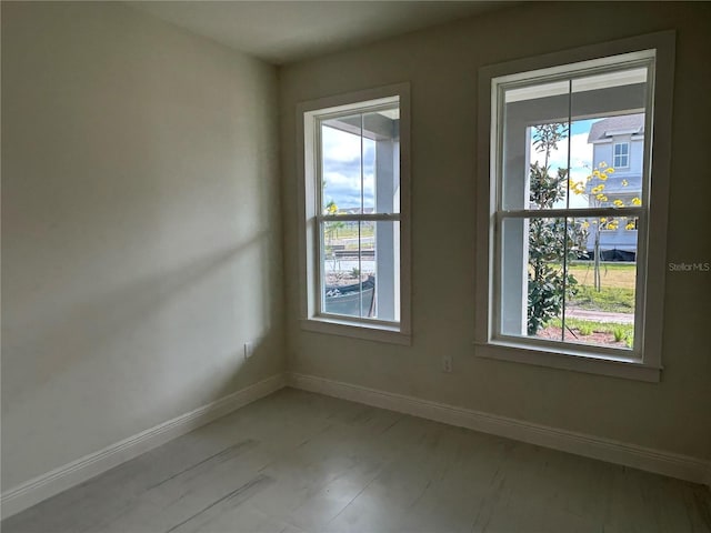 empty room featuring light wood-type flooring and a wealth of natural light