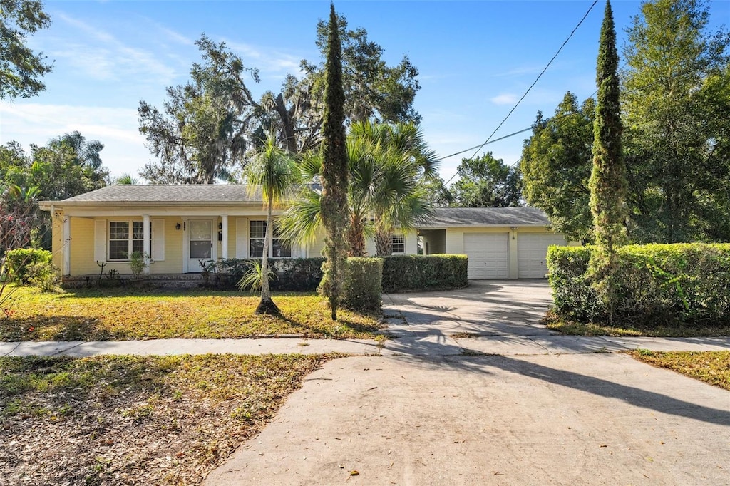 single story home with a porch and a garage