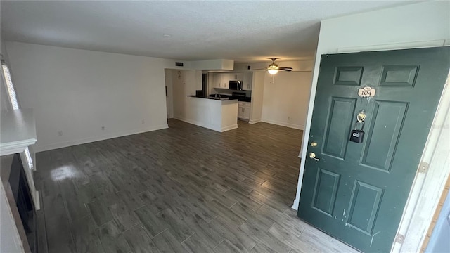 interior space with hardwood / wood-style floors and ceiling fan