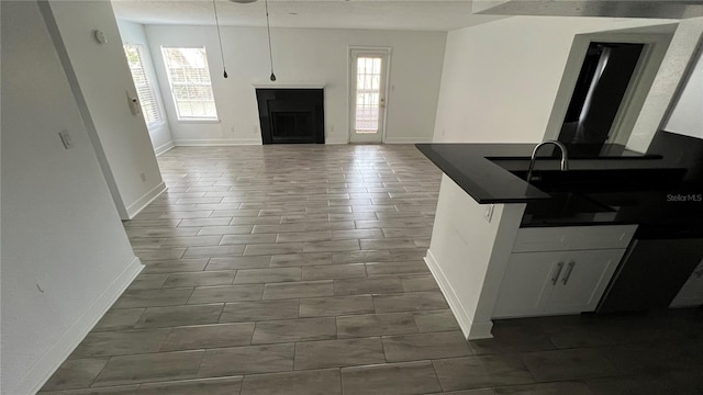 kitchen with decorative light fixtures and white cabinetry