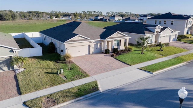 view of front of home with a garage and a front lawn