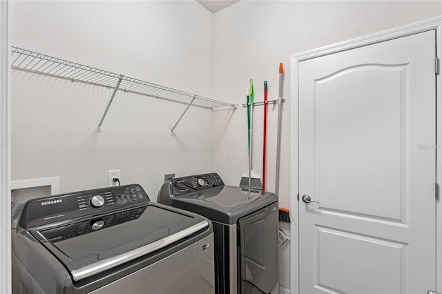 clothes washing area with independent washer and dryer