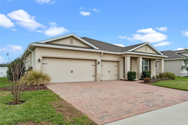 ranch-style house with a garage and a front lawn