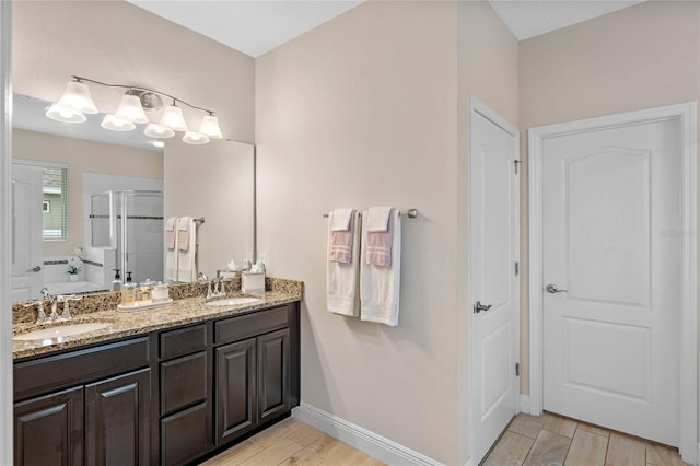 bathroom featuring vanity and an enclosed shower