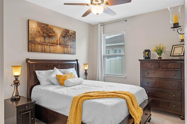 carpeted bedroom featuring ceiling fan and multiple windows