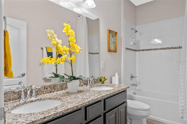 full bathroom with shower / bathtub combination with curtain, vanity, and toilet