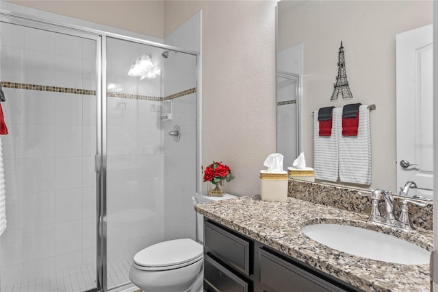 bathroom with vanity, toilet, and walk in shower