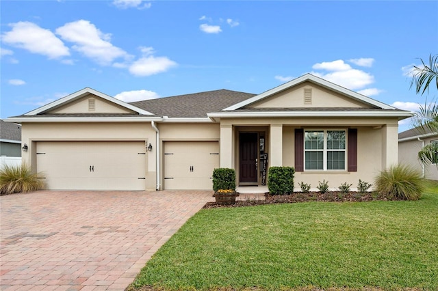 view of front of house with a garage and a front lawn