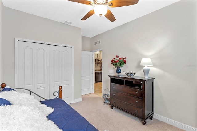 bedroom with light carpet, a closet, and ceiling fan