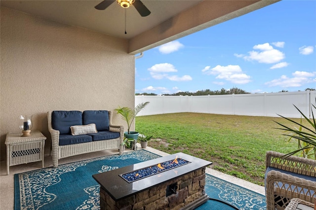 view of patio / terrace with ceiling fan and a fire pit