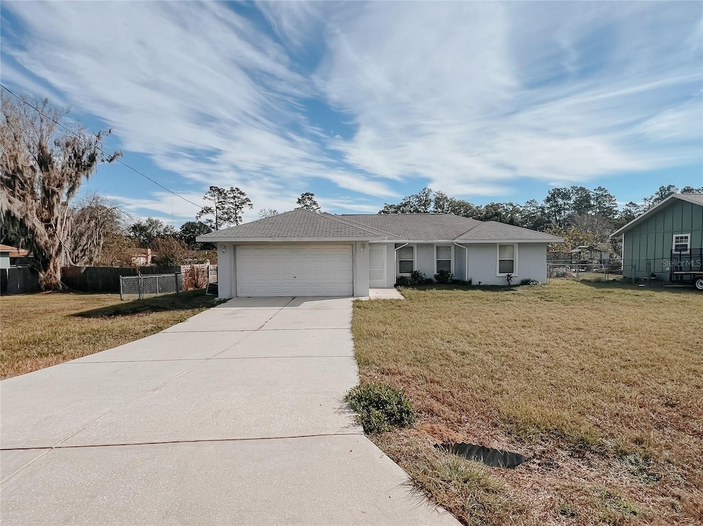 4465 NE 2nd Ct, Ocala, FL 34479 - ranch-style house with a garage and a front lawn