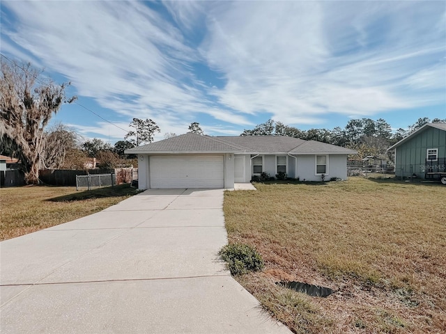 ranch-style house with a garage and a front lawn