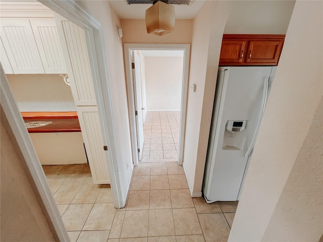 corridor with light tile patterned floors