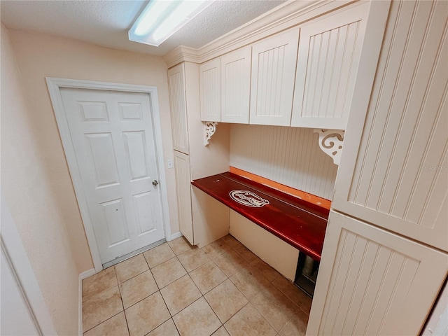 kitchen featuring light tile patterned flooring and a textured ceiling