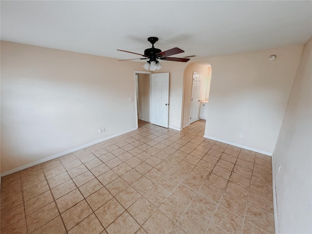 empty room with light tile patterned floors and ceiling fan