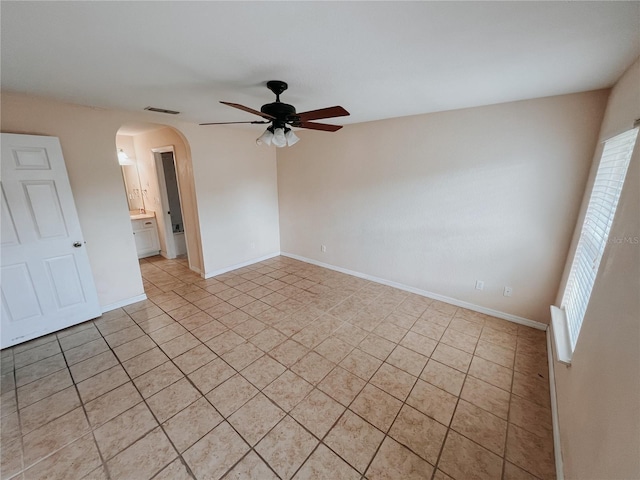 tiled empty room with ceiling fan