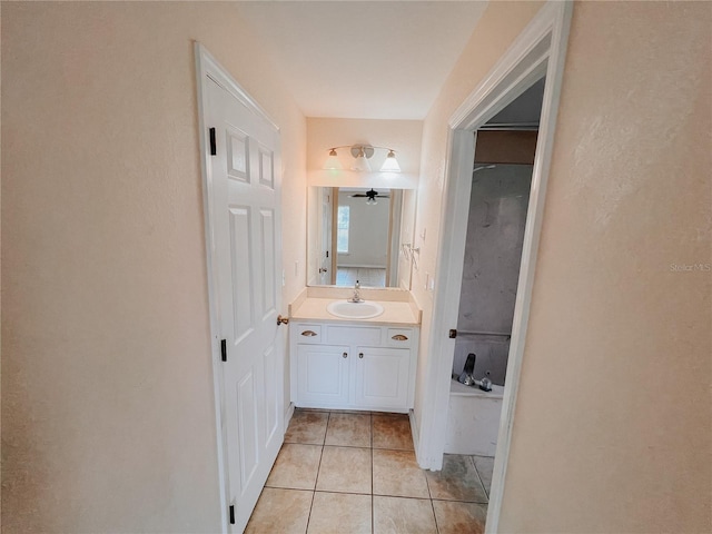 bathroom with tile patterned flooring, vanity, and ceiling fan