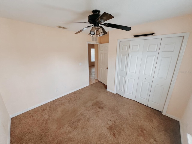 unfurnished bedroom with ceiling fan, a closet, and light colored carpet