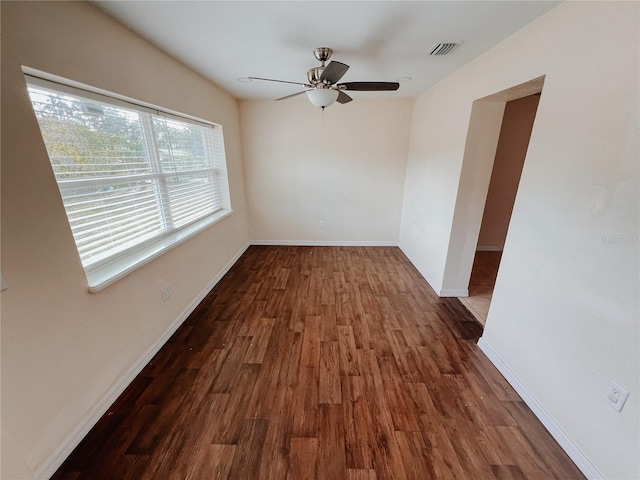 spare room featuring ceiling fan and dark hardwood / wood-style floors