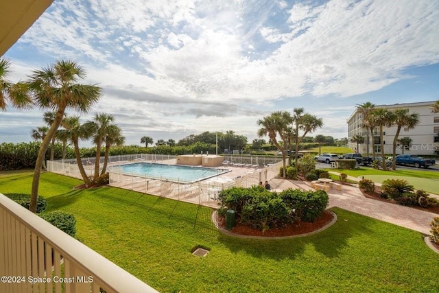 view of pool with a yard and a patio area