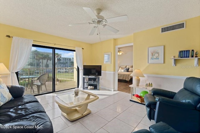 living room with light tile patterned floors and a textured ceiling