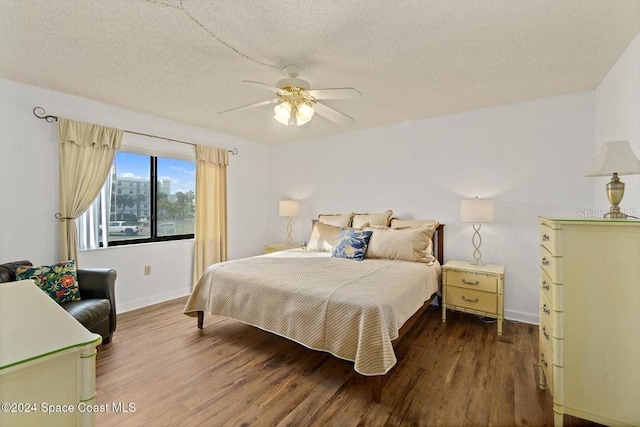 bedroom featuring ceiling fan, a textured ceiling, and hardwood / wood-style flooring