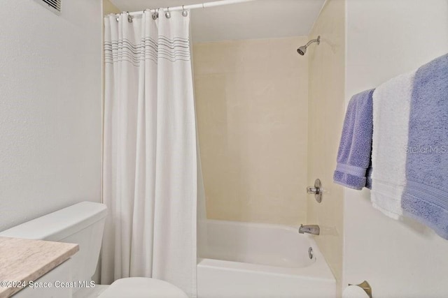 full bathroom with vanity, shower / tub combo, and toilet