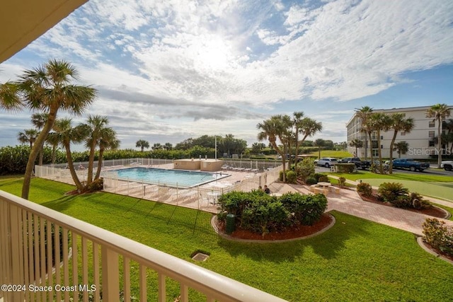 view of swimming pool with a lawn and a patio