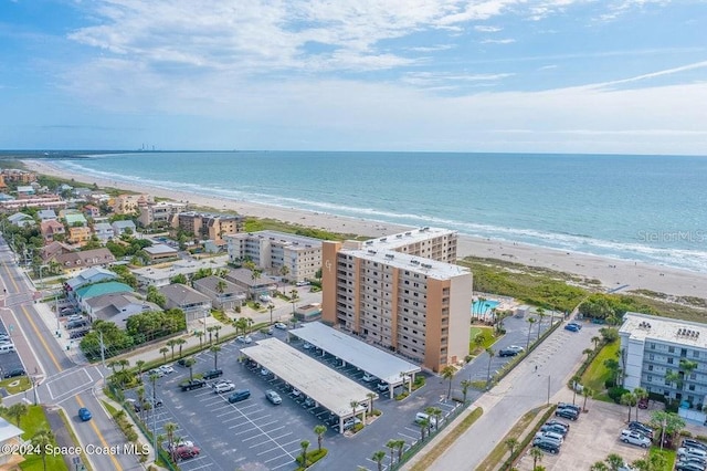 birds eye view of property with a water view and a view of the beach