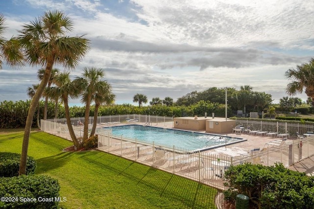 view of swimming pool with a yard and a patio