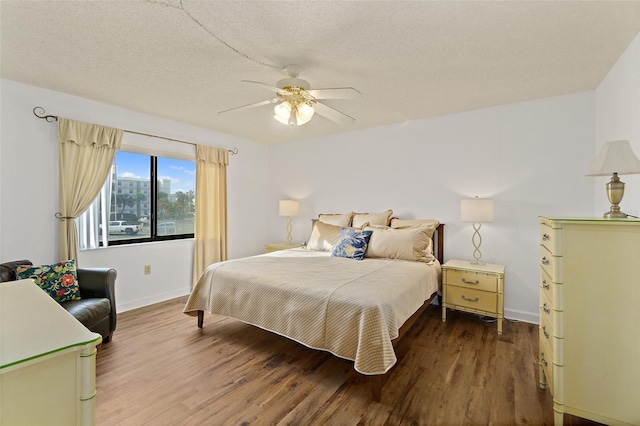 7520 Ridgewood Ave Unit 205, Cape Canaveral, FL 32920 - bedroom featuring baseboards, a ceiling fan, wood finished floors, and a textured ceiling