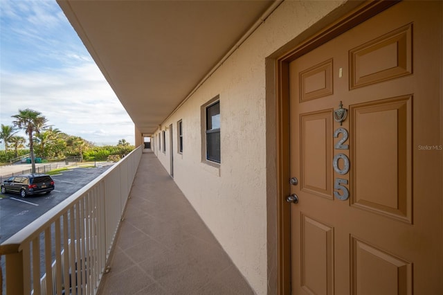 7520 Ridgewood Ave Unit 205, Cape Canaveral, FL 32920 - entrance to property featuring a balcony, stucco siding, and uncovered parking