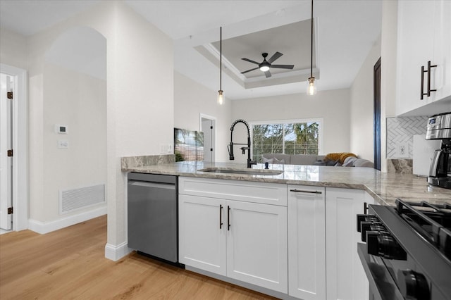 kitchen featuring white cabinetry, sink, hanging light fixtures, and appliances with stainless steel finishes