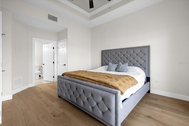 bedroom with hardwood / wood-style floors, ensuite bath, ceiling fan, and crown molding