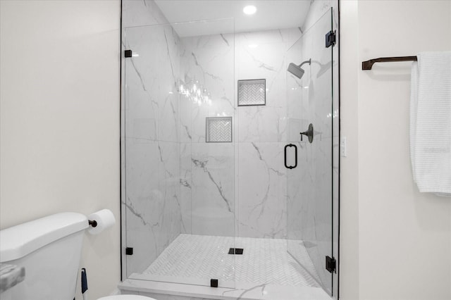 bathroom featuring toilet and an enclosed shower